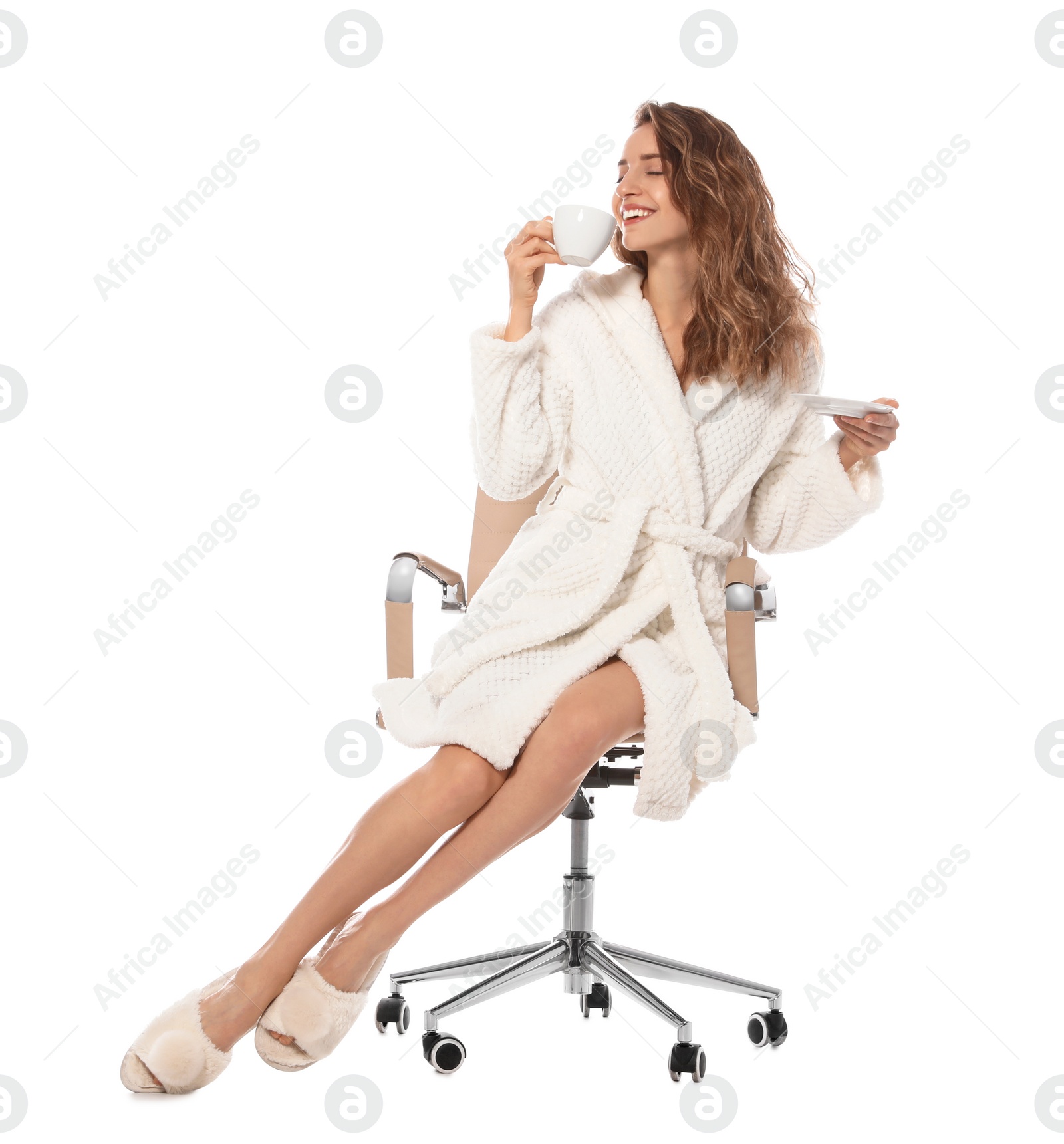 Photo of Beautiful young woman wearing bathrobe sitting in chair on white background