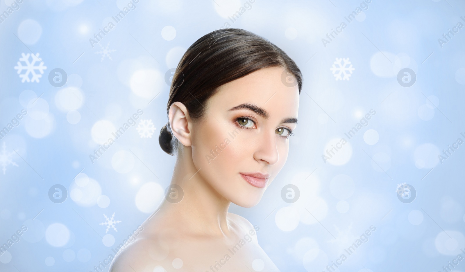 Image of Young woman with perfect smooth skin on light blue background, bokeh effect 