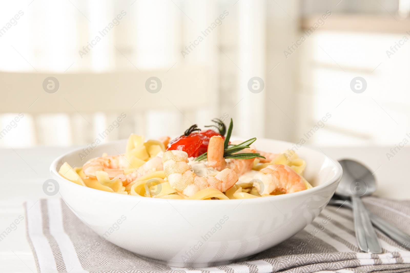 Photo of Delicious pasta with shrimps on table indoors