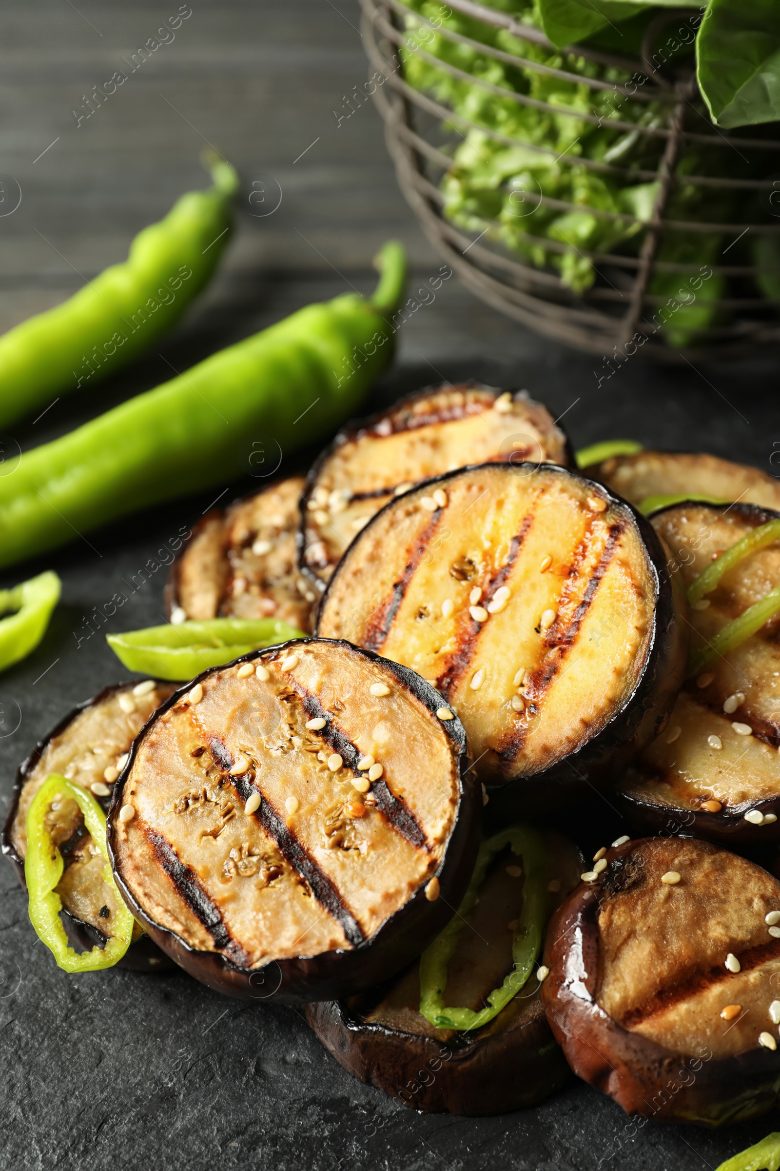 Photo of Slate plate with fried eggplant slices, closeup