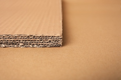 Photo of Closeup view of corrugated cardboard sheets, space for text. Recyclable packaging material