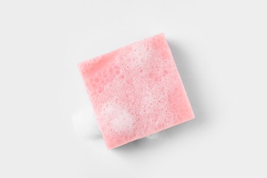 Photo of Soap with fluffy foam on white background, top view