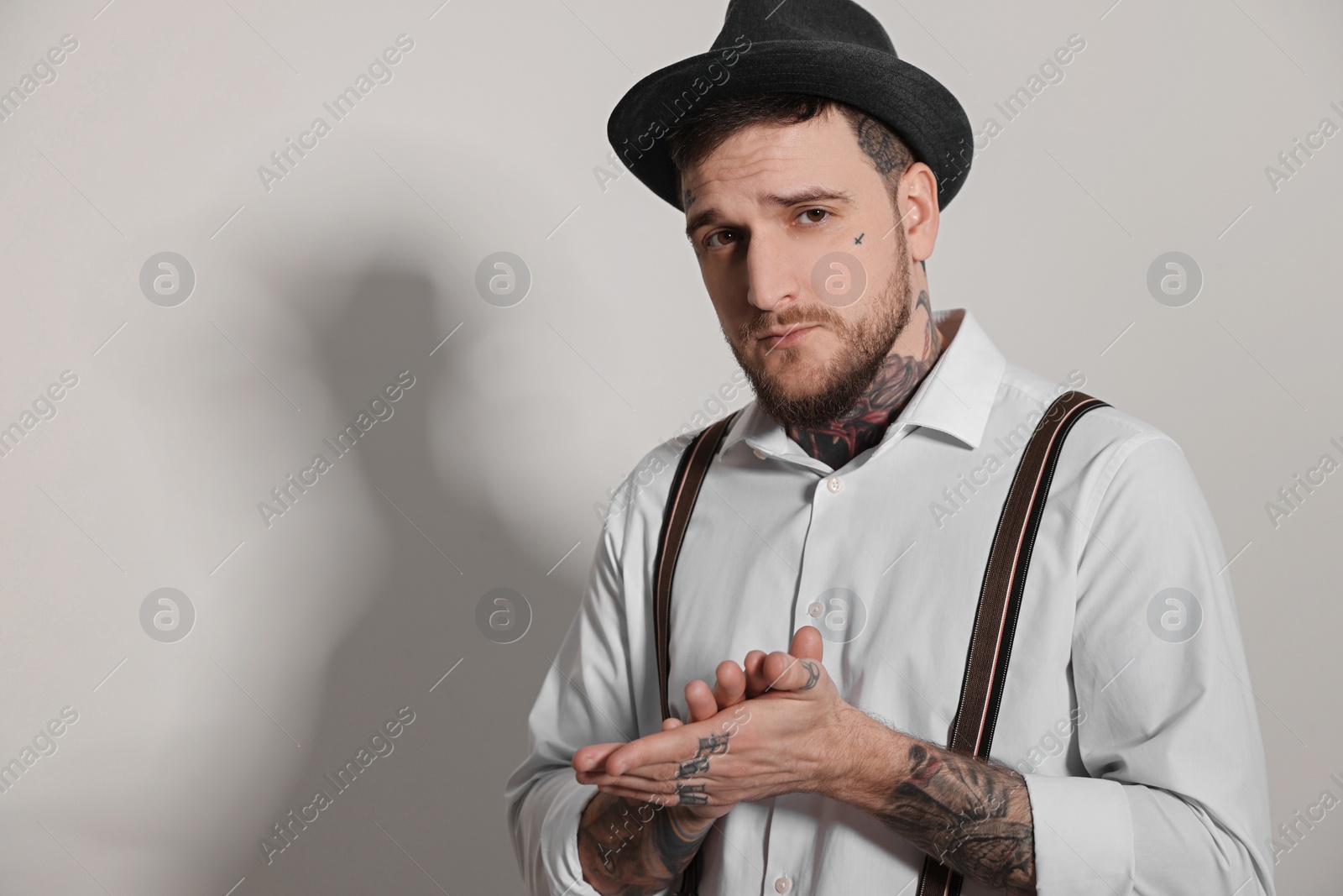 Photo of Portrait of handsome hipster man on light grey background. Space for text