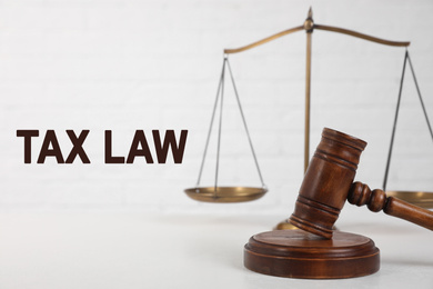 Image of Judge's gavel, scales and text TAX LAW on white background