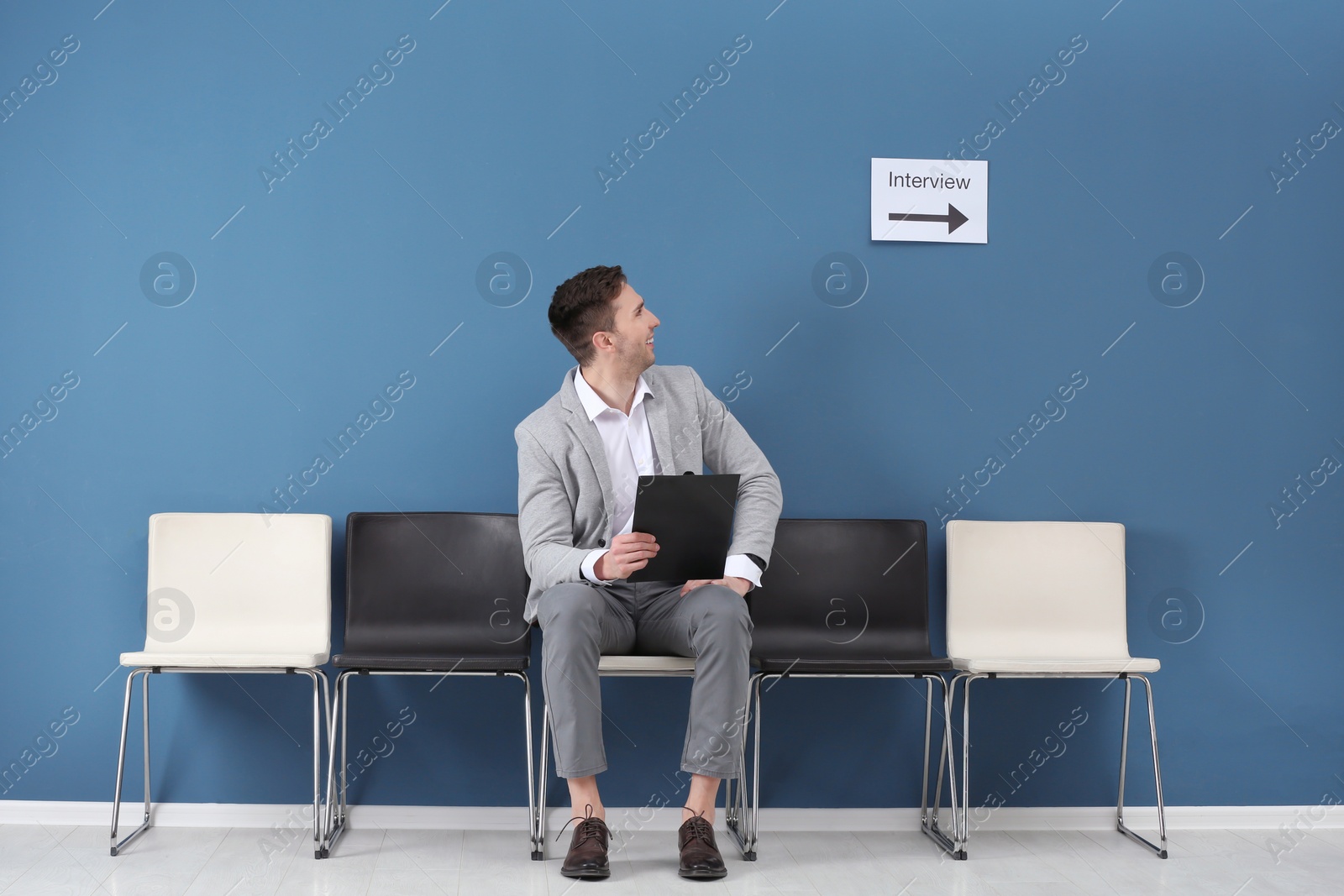 Photo of Young man waiting for job interview, indoors