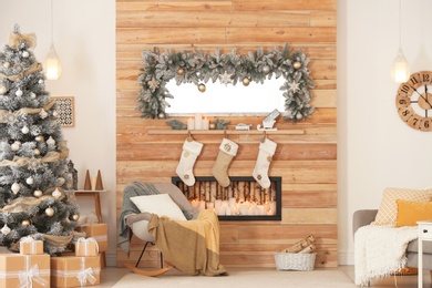 Photo of Beautiful Christmas interior of living room with decorative fireplace