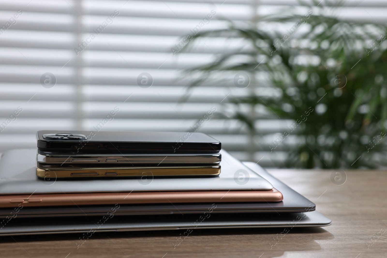 Photo of Many different modern gadgets on wooden table indoors. Space for text