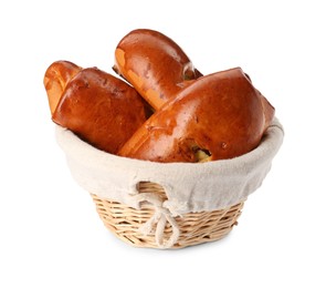 Wicker basket with delicious baked patties on white background