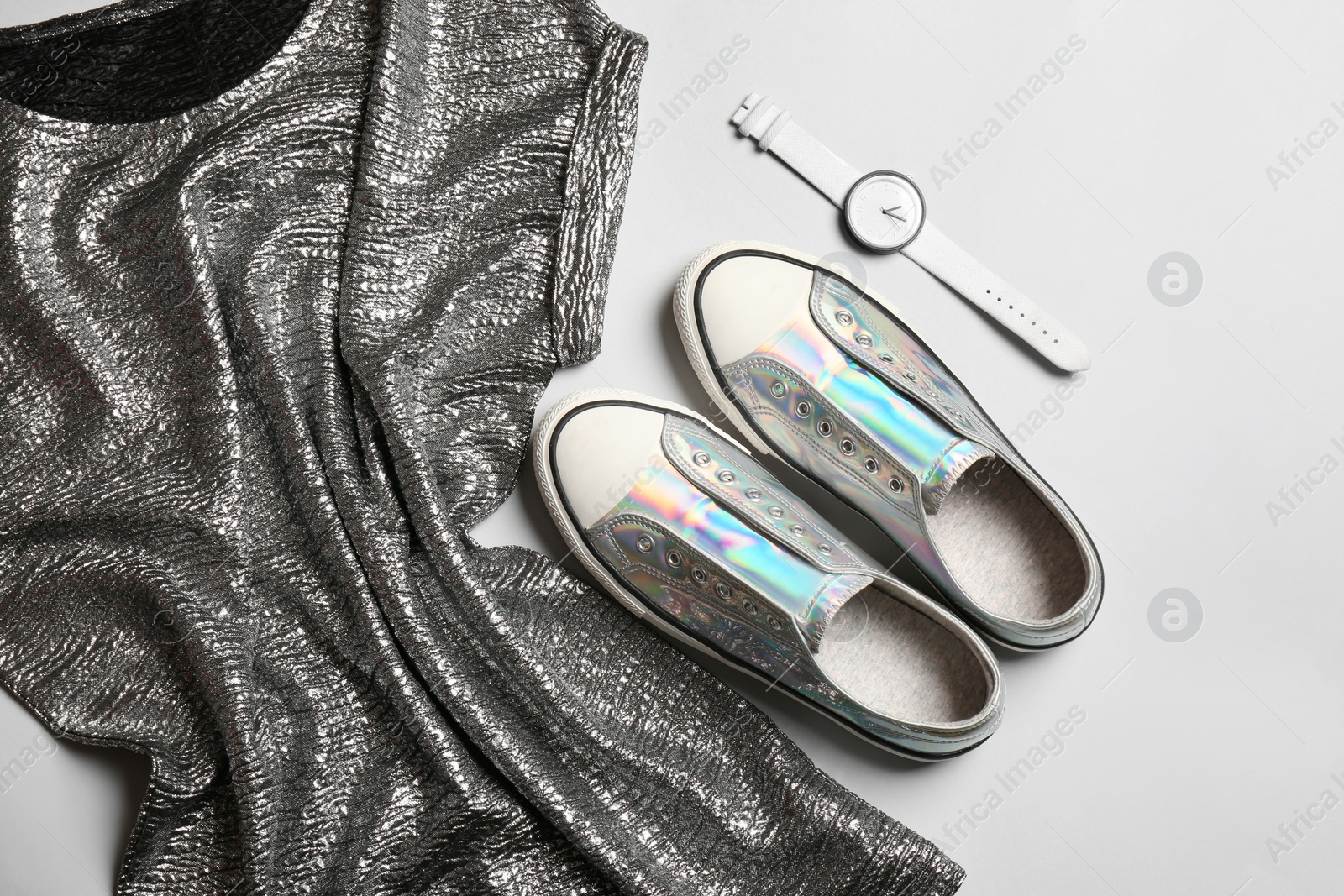 Photo of Flat lay composition with stylish sneakers on light background