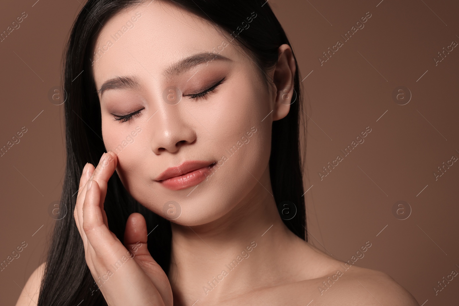 Photo of Portrait of beautiful woman on brown background