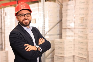 Manager in hardhat at warehouse. Logistic center