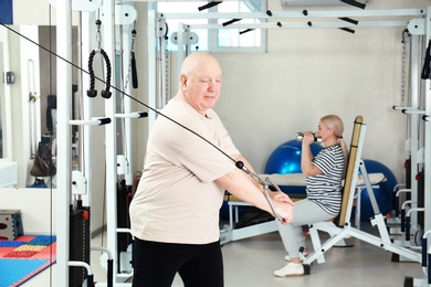 Photo of Senior patient exercising in modern rehabilitation center