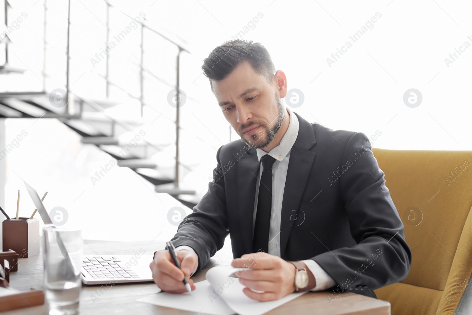 Photo of Male lawyer working in office