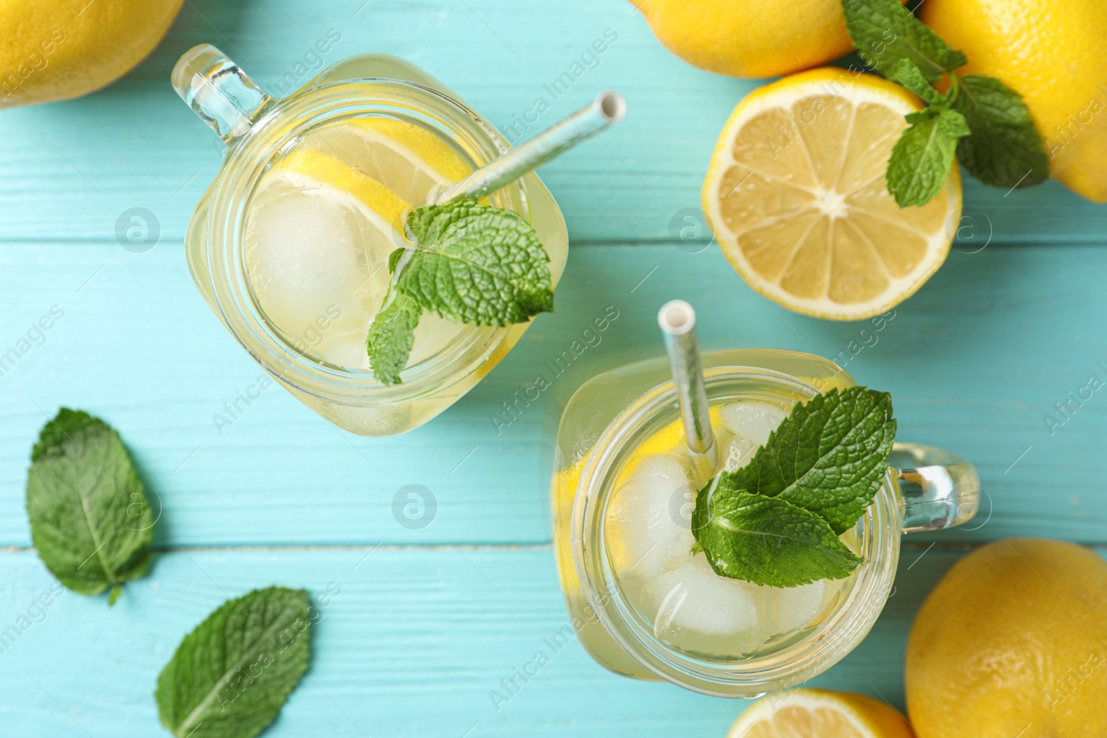 Photo of Natural lemonade with mint on light blue wooden table, flat lay. Summer refreshing drink