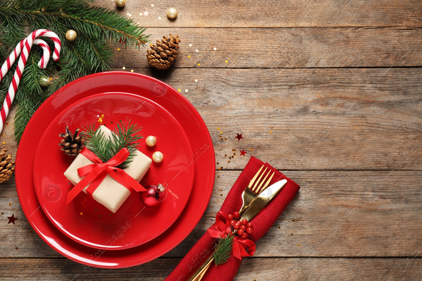 Photo of Beautiful Christmas table setting on wooden background, top view. Space for text