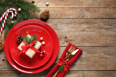 Photo of Beautiful Christmas table setting on wooden background, top view. Space for text