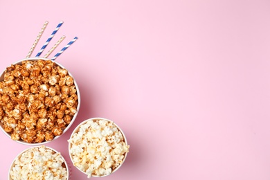 Photo of Different kinds of popcorn on color background, top view. Space for text