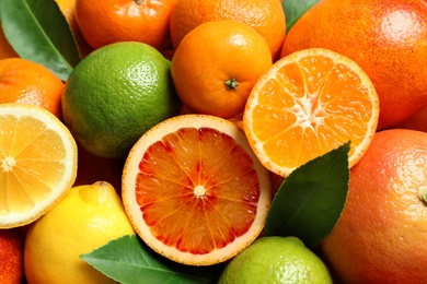 Photo of Different citrus fruits as background, top view