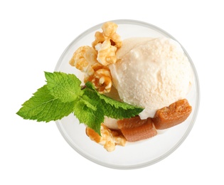 Photo of Glass bowl of ice cream with caramel candies, mint and popcorn on white background, top view