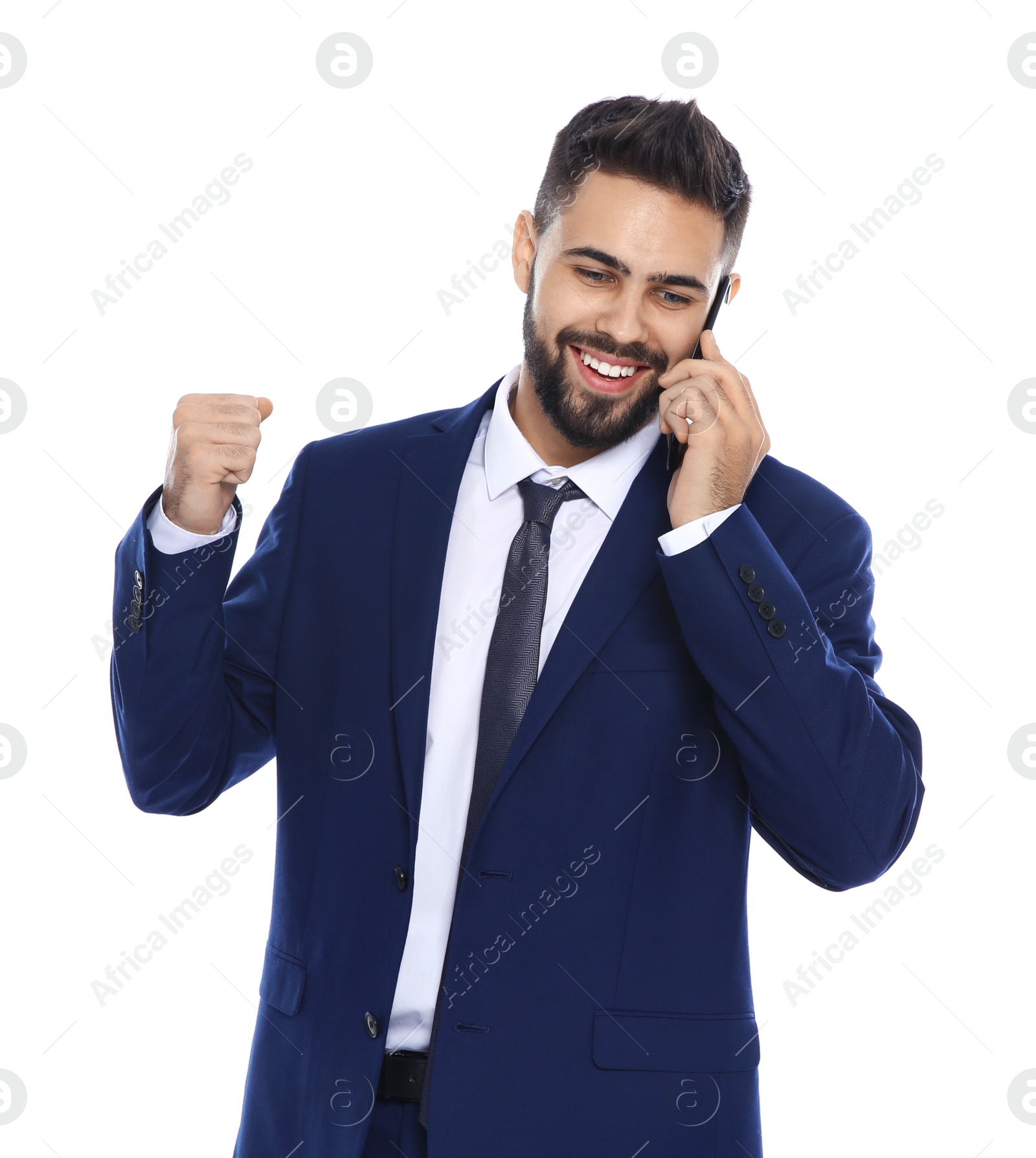 Photo of Happy young businessman with smartphone celebrating victory on white background