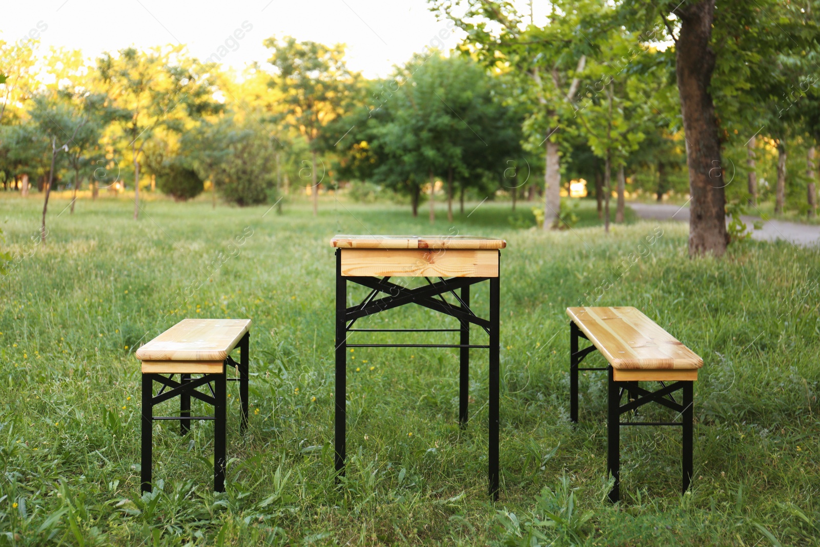 Photo of Wooden picnic table with benches in park