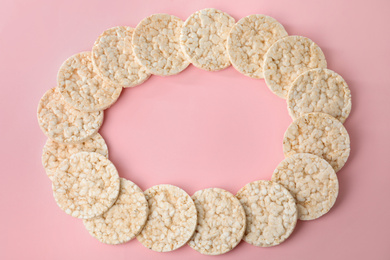 Frame made of puffed rice cakes on pink background, flat lay. Space for text