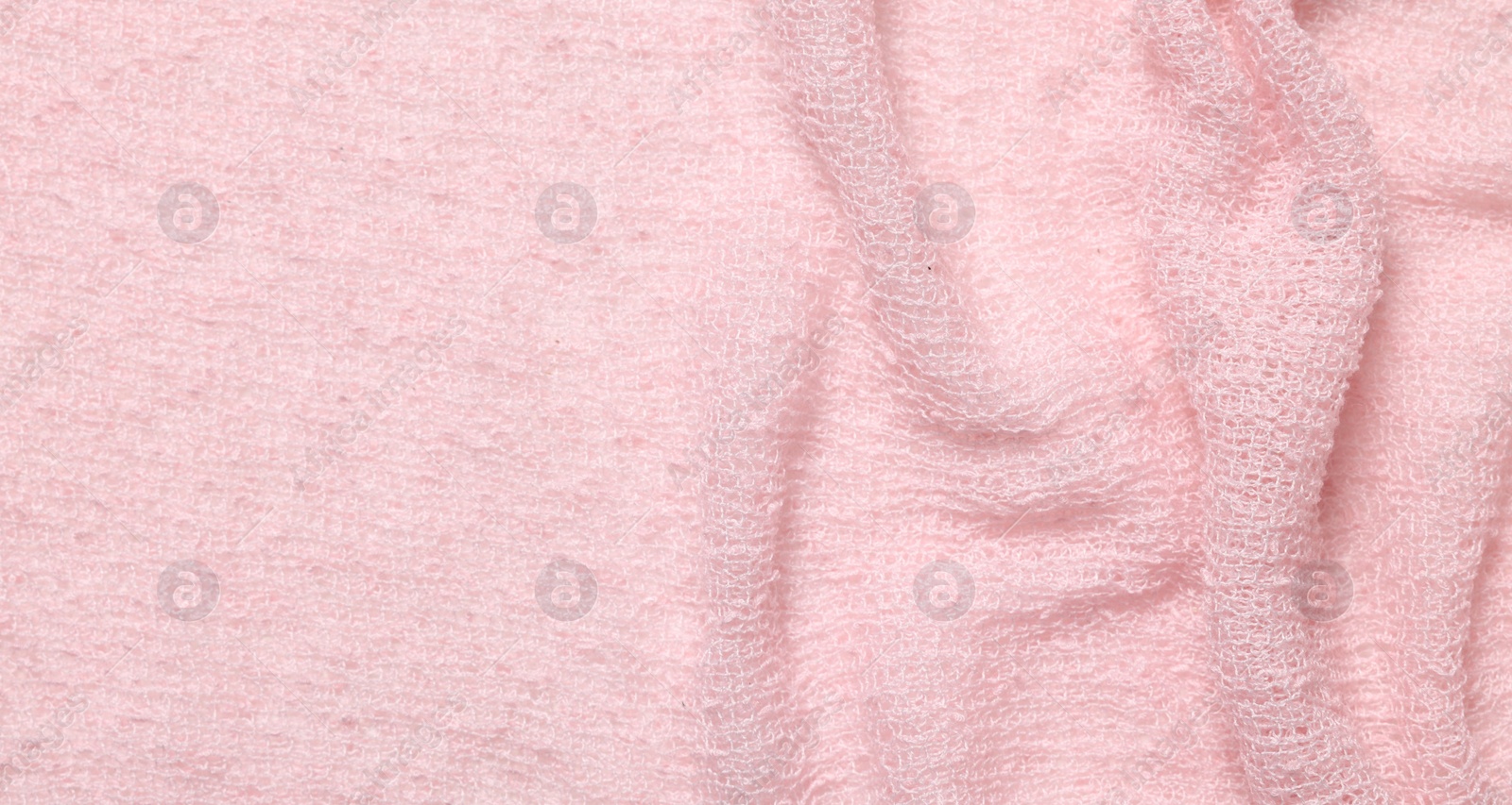 Photo of Texture of soft pink crumpled fabric as background, top view