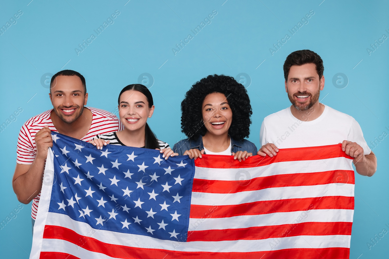 Photo of 4th of July - Independence Day of USA. Happy friends with American flag on light blue background