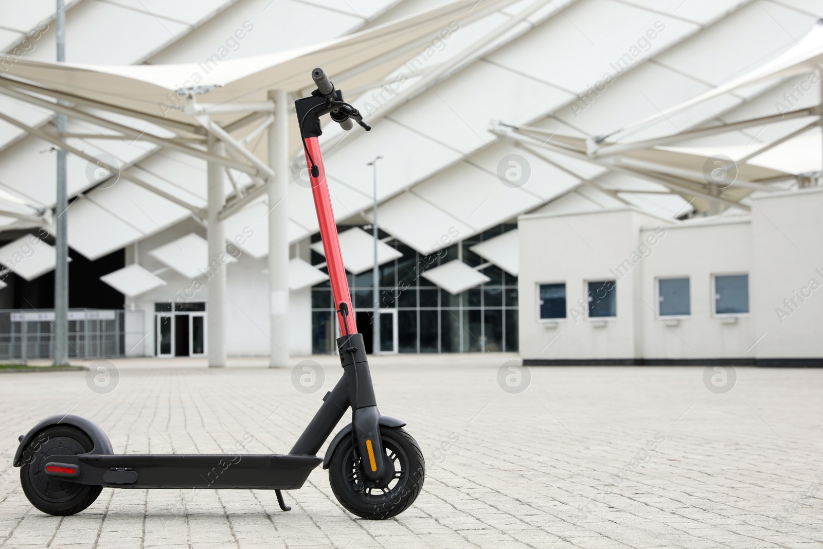 Photo of Modern electric scooter outdoors on sunny day, space for text. Rental service