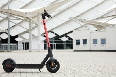 Photo of Modern electric scooter outdoors on sunny day, space for text. Rental service