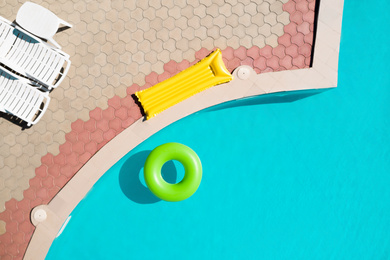 Image of Inflatable ring floating in swimming pool, top view. Summer vacation