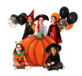 Cute little kids with balloons and decorative pumpkin wearing Halloween costumes on white background