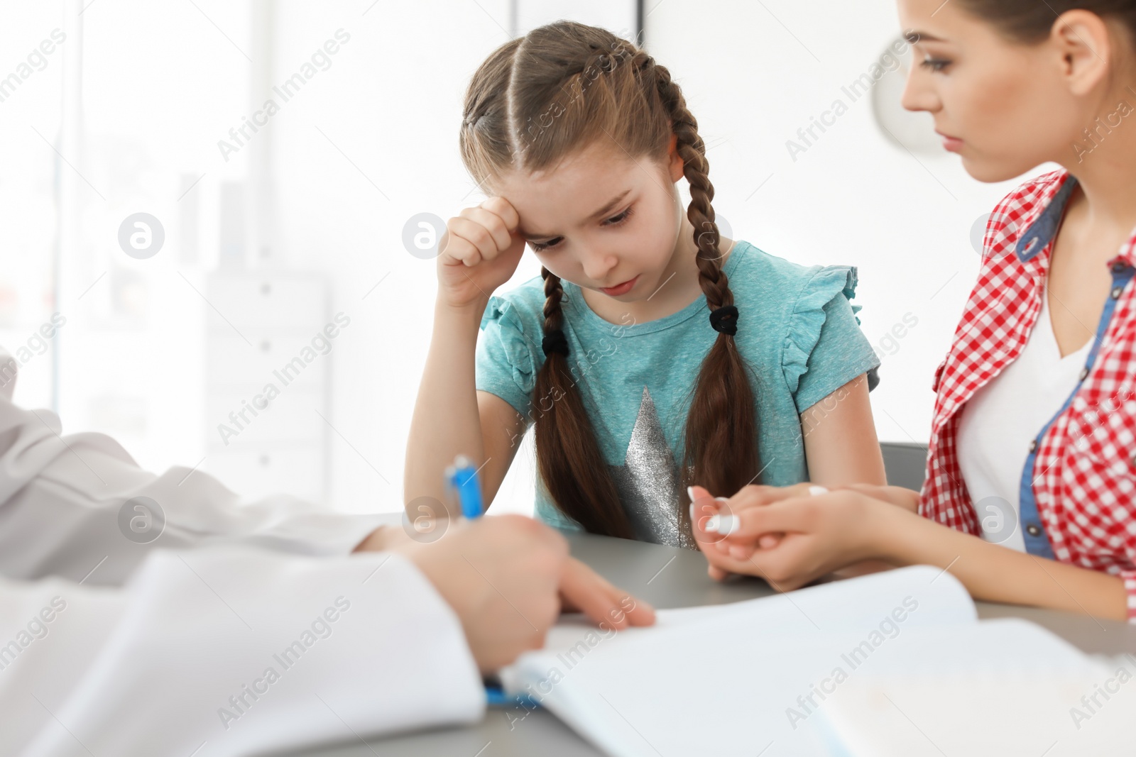 Photo of Young woman with her daughter having appointment at child psychologist office