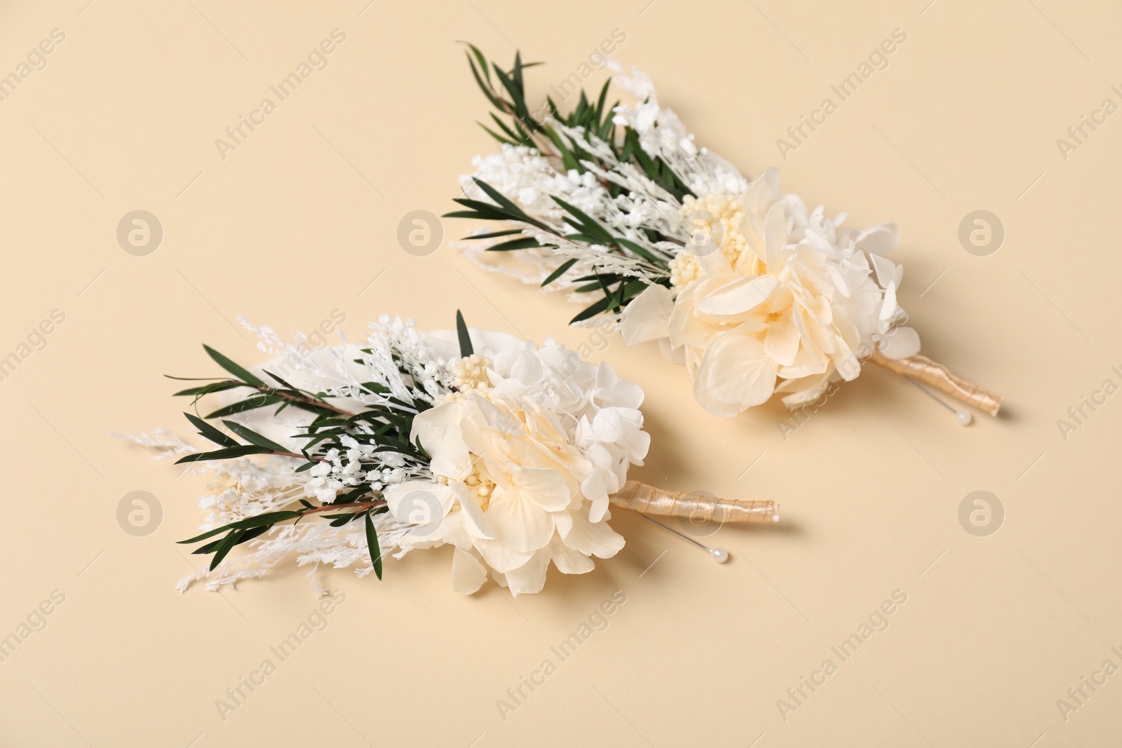 Photo of Stylish boutonniere on beige background, above view