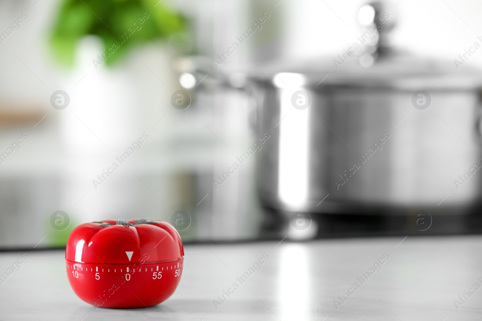 Photo of Kitchen timer in shape of tomato on white table indoors. Space for text