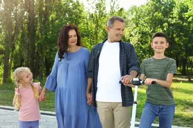 Couple of pensioners with grandchildren in park