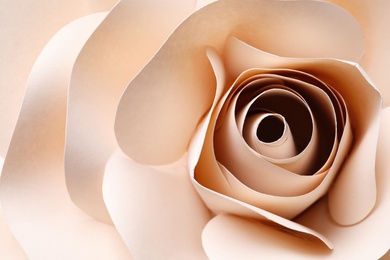 Beautiful beige flower made of paper as background, top view