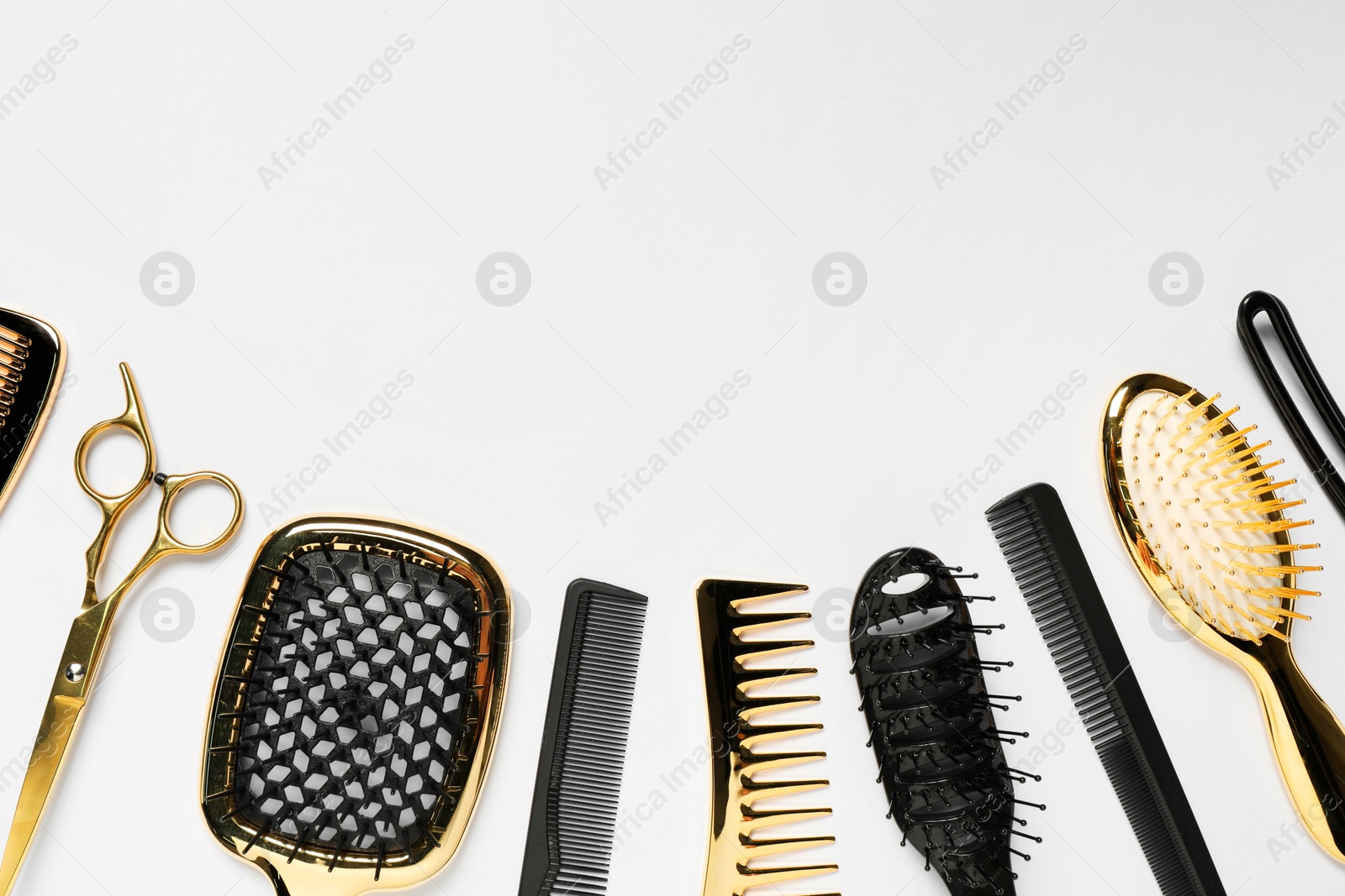 Photo of Hairdressing tools on white background, flat lay. Space for text