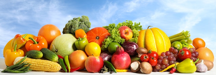 Assortment of fresh organic fruits and vegetables on table outdoors. Banner design