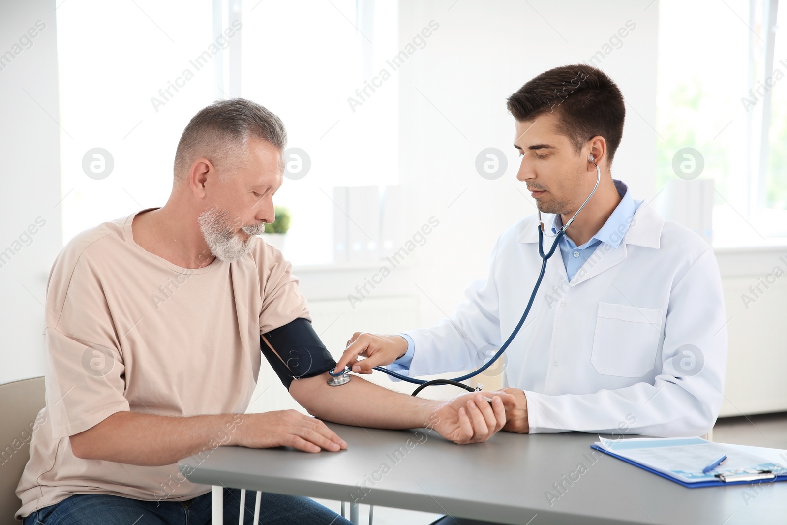 Photo of Doctor measuring patient's blood pressure in hospital