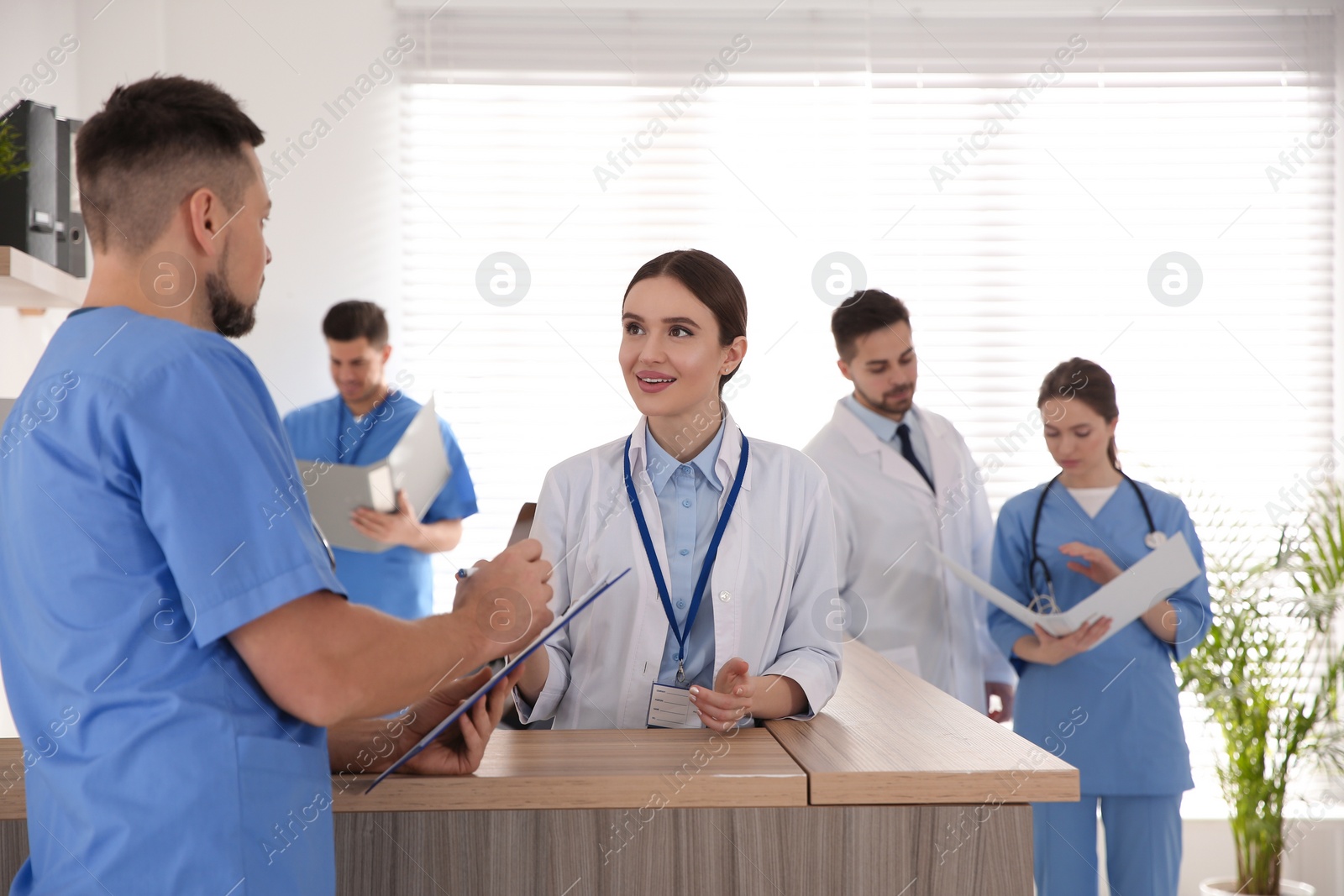 Photo of View of modern clinic with working doctors