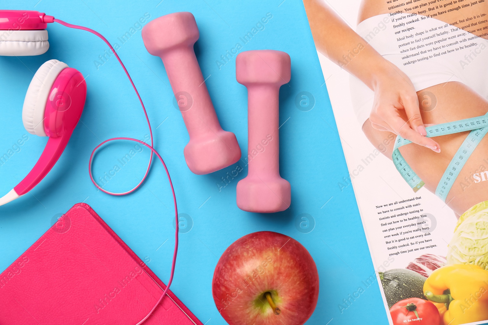 Photo of Flat lay composition with dumbbells on light blue background