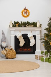 Cozy living room with fireplace and Christmas decor. Interior design
