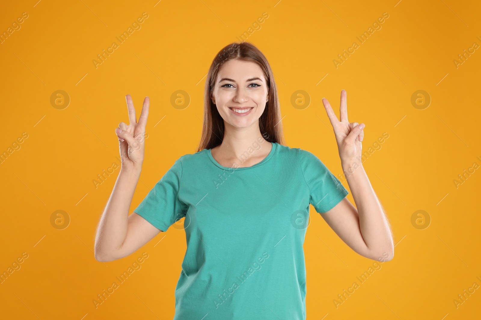 Photo of Woman showing number four with her hands on yellow background