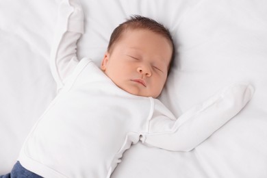 Photo of Cute newborn baby sleeping on white blanket