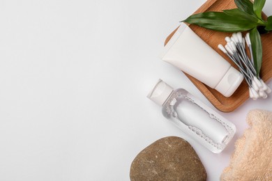 Photo of Flat lay composition with bottle of micellar cleansing water on white background, space for text