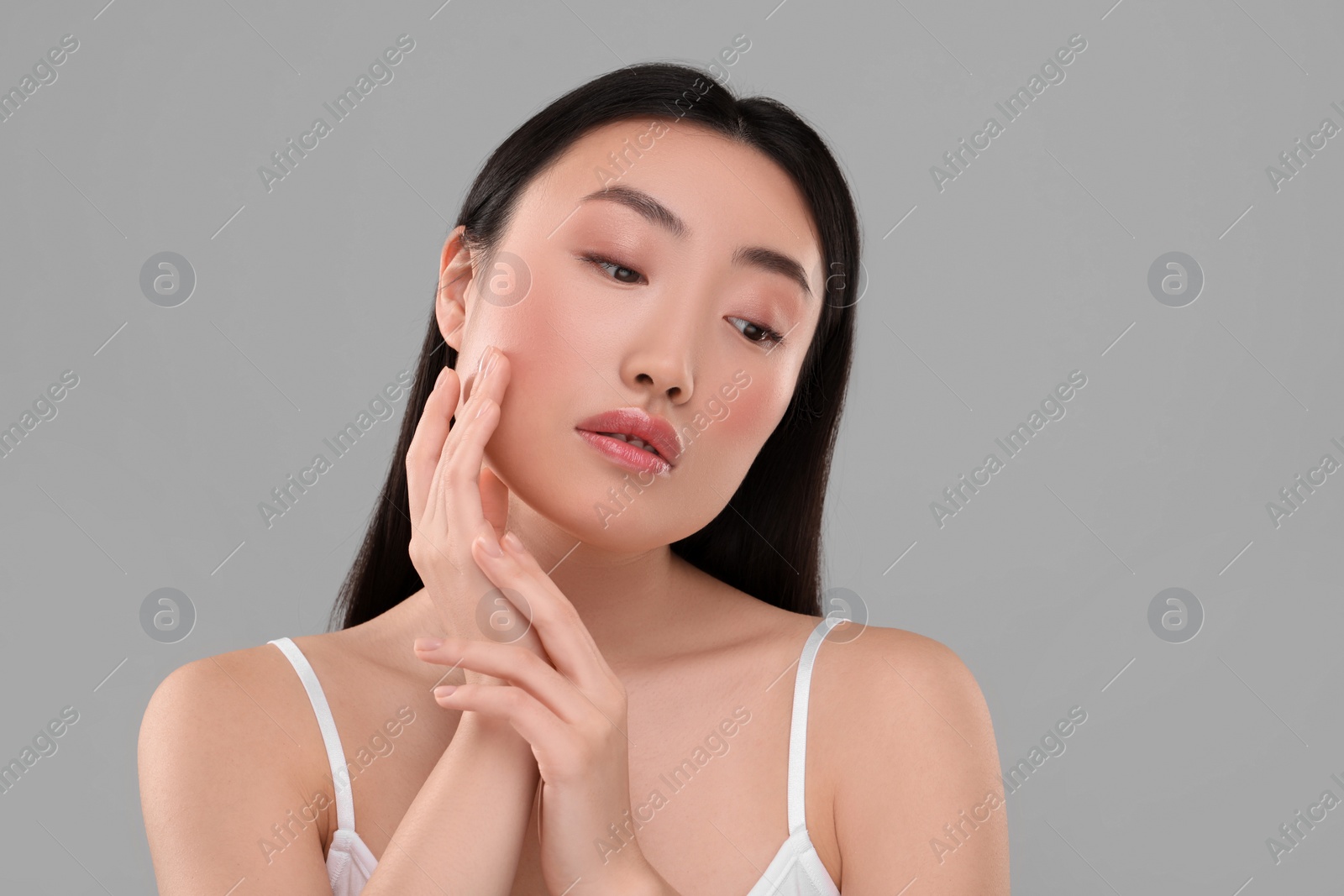 Photo of Beautiful woman with healthy skin on gray background