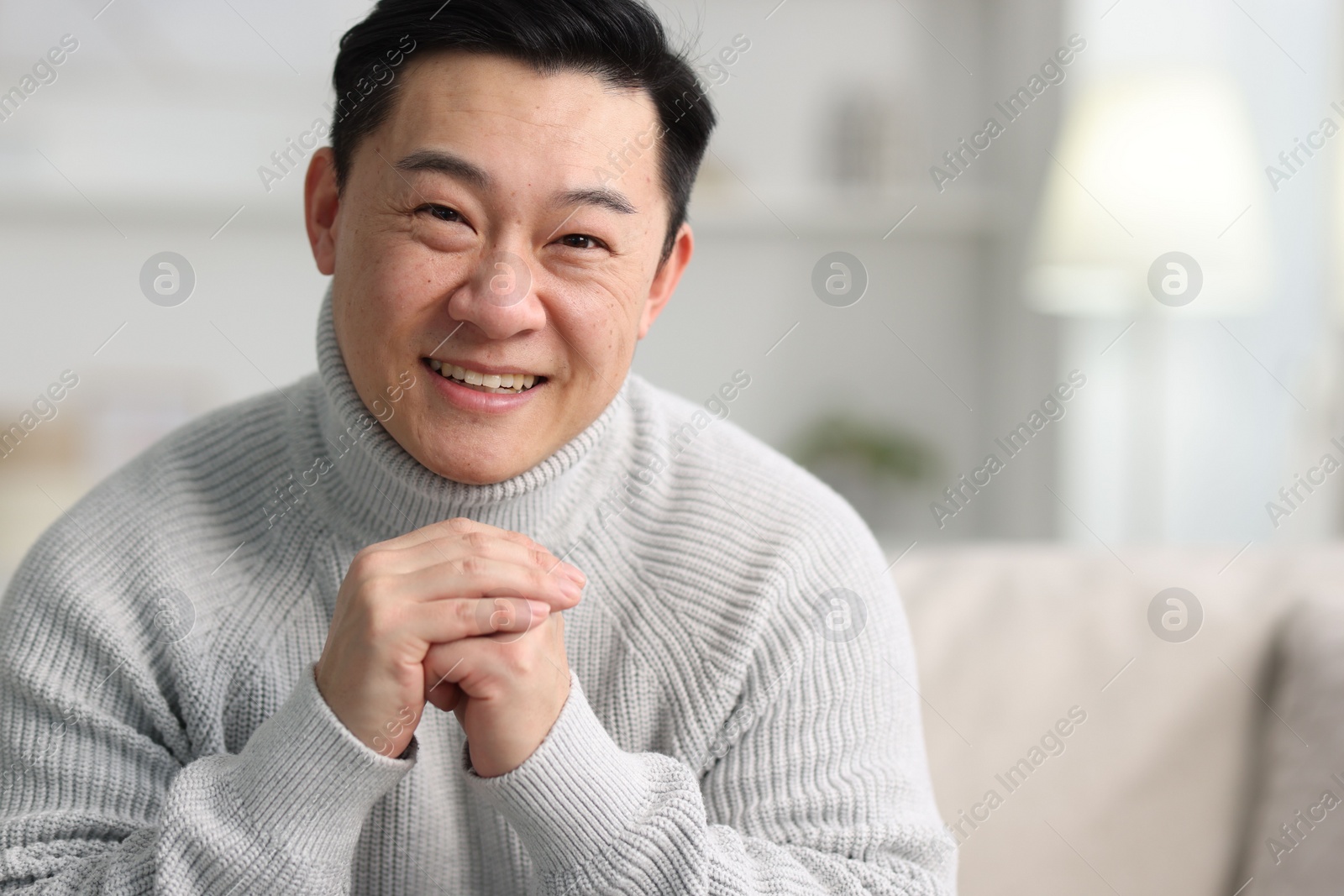 Photo of Portrait of smiling man on blurred background. Space for text