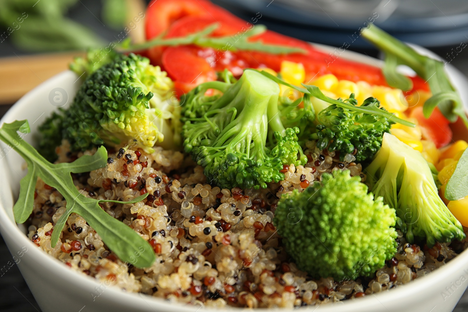 Photo of Bowl with quinoa and different vegetables, closeup