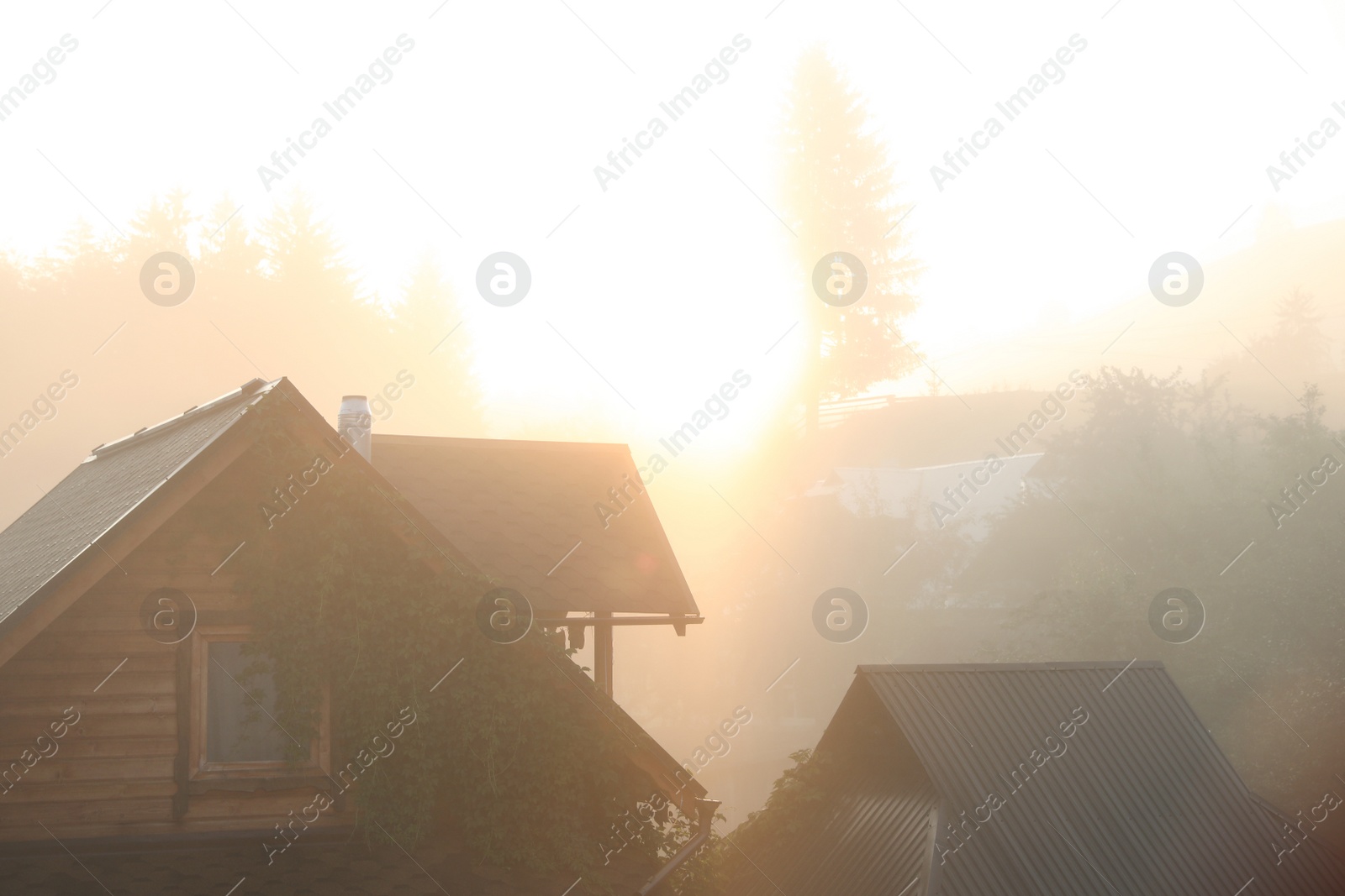 Photo of Beautiful view of sunrise over wooden houses
